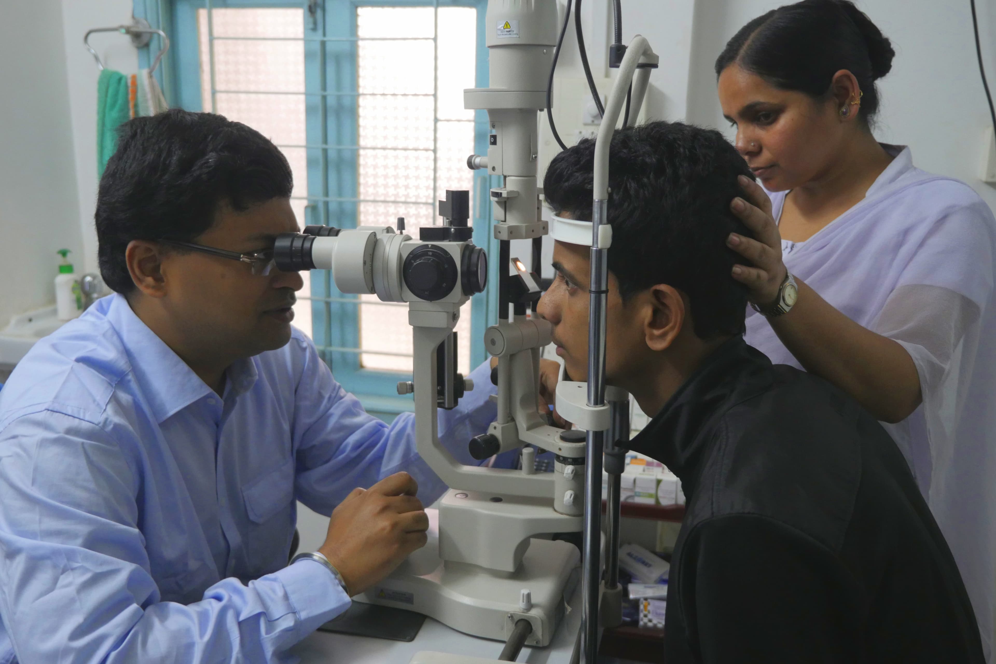 An ophthalmologist examining a patient at a clinic in Alipurduar, India